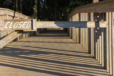 View of text on footpath by trees