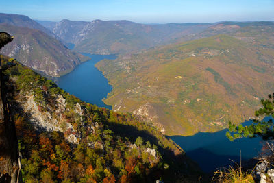 High angle view of lake amidst mountains against sky