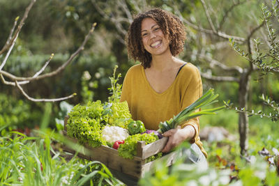 Young woman smiling with plants