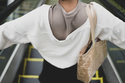 Midsection of woman holding umbrella