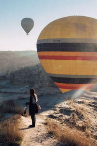 Rear view of man with hot air balloon