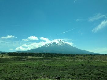 Scenic view of snowcapped mountains against blue sky