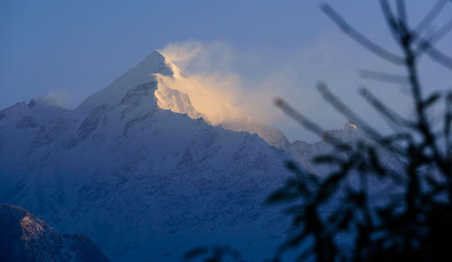 Scenic view of snowcapped mountains against sky during sunset