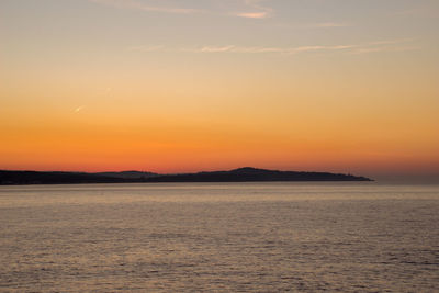 Scenic view of sea against romantic sky at sunset