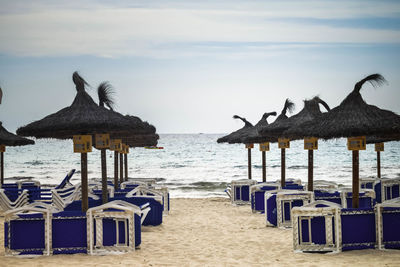 Parasols on beach against sky looking out to sea