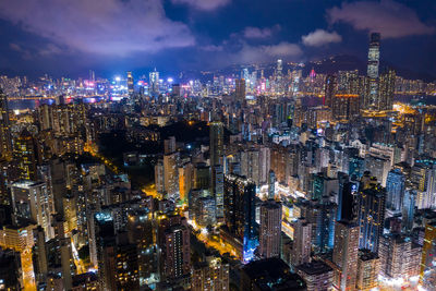 High angle view of illuminated cityscape against sky at night