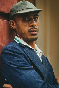 Portrait of young man wearing hat standing outdoors