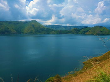 Scenic view of lake and mountains against sky