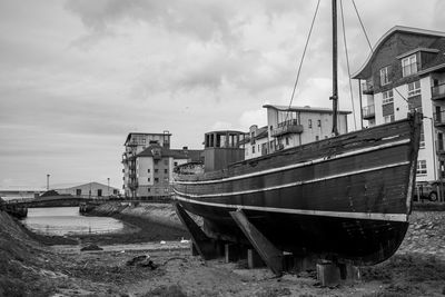 Abandoned boats on land against sky