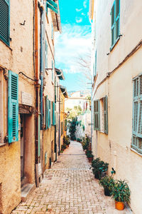 Alley amidst buildings against sky