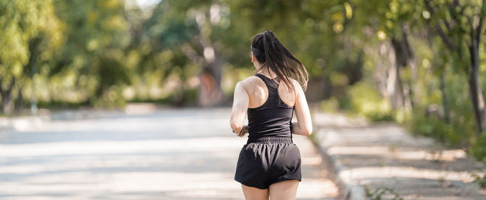 Rear view of woman standing outdoors