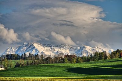 Scenic view of landscape against cloudy sky