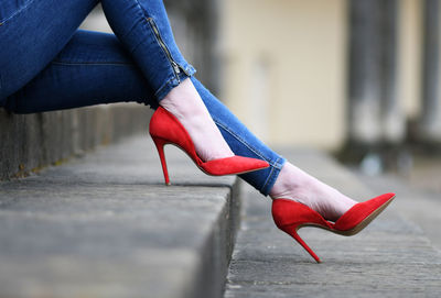 Low section of woman wearing red shoes on steps