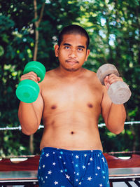 Portrait of young man exercising in gym