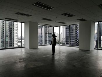 Man walking in corridor of building