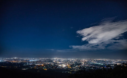 Aerial view of illuminated buildings in city at night