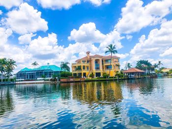 Building by lake against sky