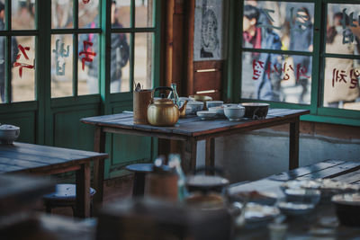 Bowls by teapot on table in restaurant