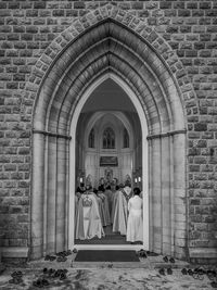 Rear view of people in front of building