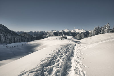 Scenic view of snow covered mountains against clear sky