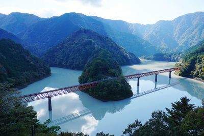 Bridge over mountains against sky