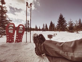 Man on snow covered field against sky