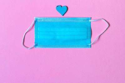 High angle view of blue colored pencils on pink background