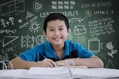 Worried boy studying at table