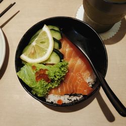 High angle view of salmon don in bowl on table