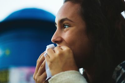 Close-up of young woman looking away