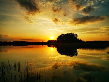 Scenic view of lake against sky during sunset