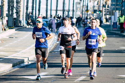 Group of people running in city