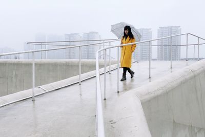 Woman walking outdoors during rainy season 