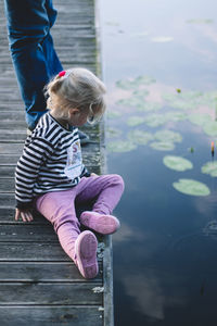 High angle view of girl on pier near water