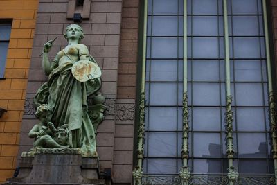 Low angle view of statue against building