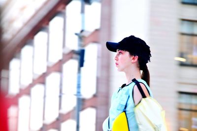 Portrait of woman wearing hat standing outdoors