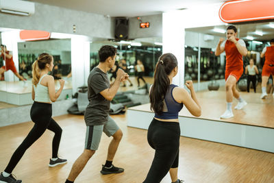 Rear view of woman exercising in gym