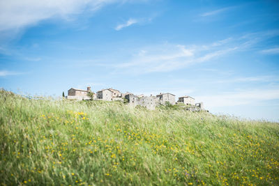 Built structure on field against sky