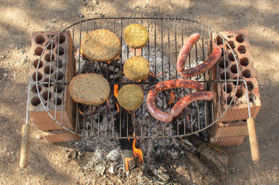 High angle view of meat on barbecue grill