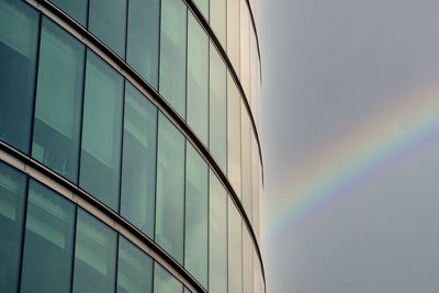 Low angle view of glass building against sky