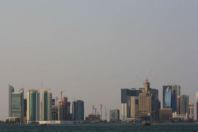 Modern buildings in city against clear sky