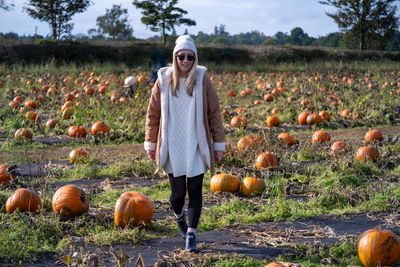 Portrait of woman standing on field