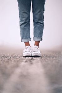 Low section of girl standing on road