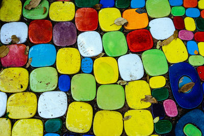 Top view on pieces of multicolored ceramic tiles decorated in garden. old pavement of tiles textured