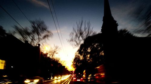 Cars moving on road at sunset