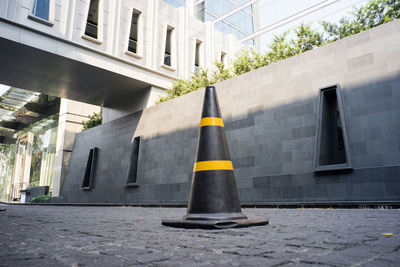 Traffic cone on street by building