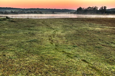 Scenic view of lake against sky during sunset