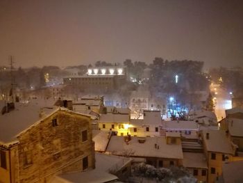 View of town against sky at night