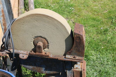 High angle view of old rusty wheel on field