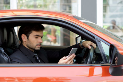 Portrait of young man in car